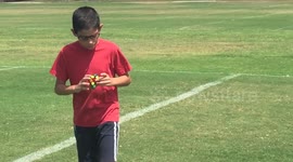11 year old kid displays incredible multitasking skills by solving a rubik's cube while juggling a soccer ball
