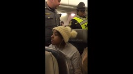 Liberal being escorted off plane front view
