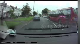Bus overtakes on the wrong side of a traffic island narrowly avoiding collision