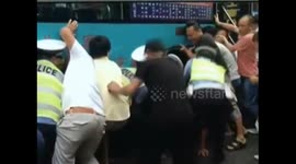 Good Samaritans lift up bus to rescue trapped woman