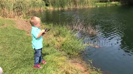 Little boy fishing.  He wasn’t expecting to reel in that!