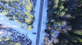 Arial shot - Volvo driving past - Winter and Snow