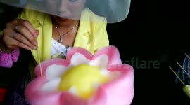 Street vendor sculpts flowers out of candy floss