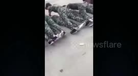 Male students perform push-ups over female classmates