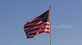 An American flag flutters in the wind