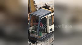 Six-year-old boy operates digger on Bangkok building site