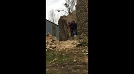 Slow-motion of wall demolition at 125 year old building in France