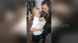Girl is overwhelmed with emotion as she is surprised with a puppy