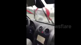 Passenger operates windscreen wipers manually with cloth