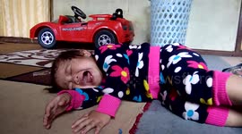 A mother is playing with the baby pacifier to make her crying