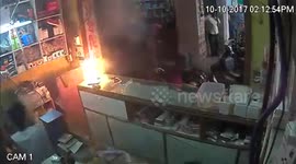 Shop employees run for cover as mobile phone explodes