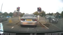 Biker runs red light really late on a busy cross road