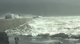 Monster waves breaking over fenit pier on the west coast of ireland