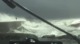 Monster waves breaking over fenit pier on the west coast of ireland