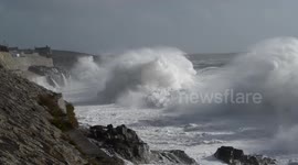 Storm waves break against Porthleven cliffs
