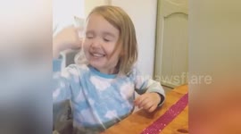 Pre-schooler pokes her face trying to 'touch her dreams'