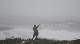 Persons Taking Selfies While Big Waves From Ophelia Hit Shore