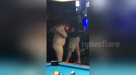 Newsflare Edit - Naked woman chasing man around pool table
