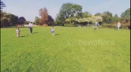 Drone flying over family in the park