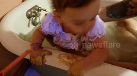 Baby Takes a Bath in Paint-Covered Clothes