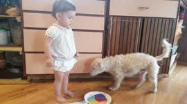Dog Sneaks Behind Baby to Avoid Paint Mess