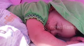 Groggy Beach Baby Wakes Up from Sandy Nap