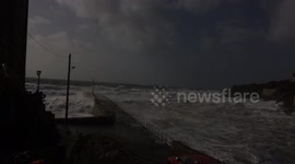 Waves breaking on porthleven pier during storm Ophelia