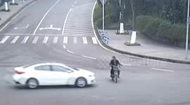 Scooter driver sent spinning over car roof
