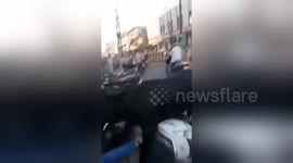 Passionate bull tries to mount motor scooter shocking its two riders