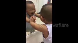 Baby sees himself in mirror for the first time