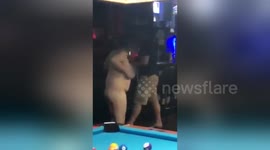 UPDATED SCRIPT: Naked woman in bar chases customer around pool table with cue