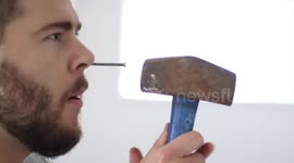 Man hammers huge nail into nose. magic trick