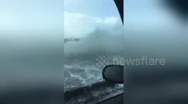 Huge waves soak moving car on Hampshire coast