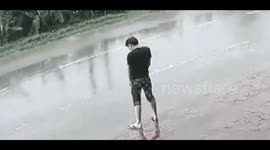 Man relieving himself on road splattered when lorry passes by