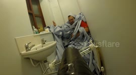 Woman uses leaf blower to bury boyfriend under blue roll