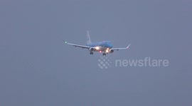 Plane is not able to land during a storm and makes a go around