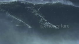 Two Surfers sharing a Monster Wave in Nazaré, Portugal