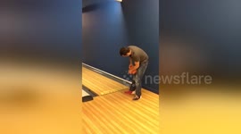 Man's fingers get stuck in bowling ball as he goes bowling for the first time