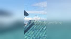 Typhoon Lan blows ferris wheel gondolas wildly in wind