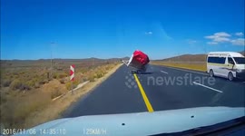 Trailer blown by wind smashes oncoming car windscreen