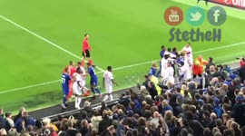Everton fan tries to hit Lyon goalkeeper while holding his son