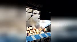 Crowd watches fire as it breaks out in Mumbai slum