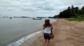 Thai Lady Walking along Beach in Thailand