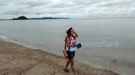 Lady Walks Along Sea Edge on a Secluded Beach in Thailand