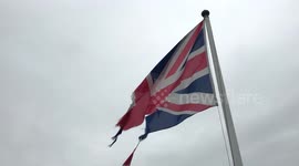 Union Jack flag flying in wind torn up and in tatters, like the Brexit negotiations.