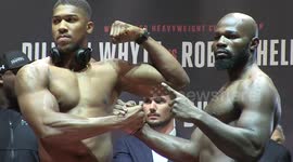 Intense! Joshua & Takam engage in extended handshake at weigh-in