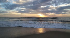 Atlantic Ocean waves crashing on the beach at sunrise in Assateague Island, Maryland, US in October