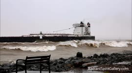 Thousand foot Laker ship heads into Lake Superior winter storm with wild waves