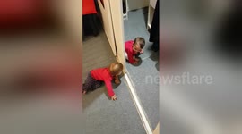 Adorable baby twins discover peek-a-boo