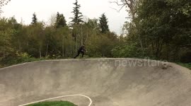 Skateboarding on a dirt BMX track
